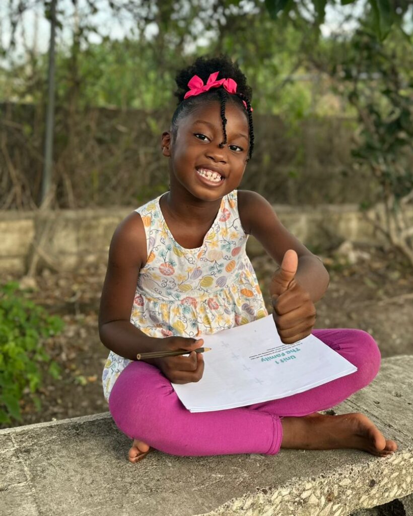 Young Jamaican girl reading.